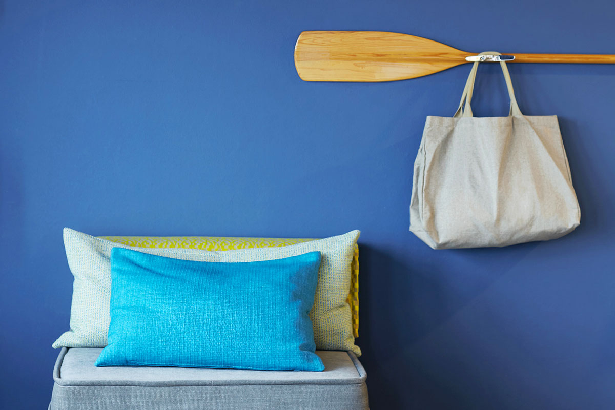 Detailaufnahme der Sitzgelegenheit mit Kissen und einer SPA-Tasche im Doppelzimmer Landblick des arborea Marina Resort Neustadt.